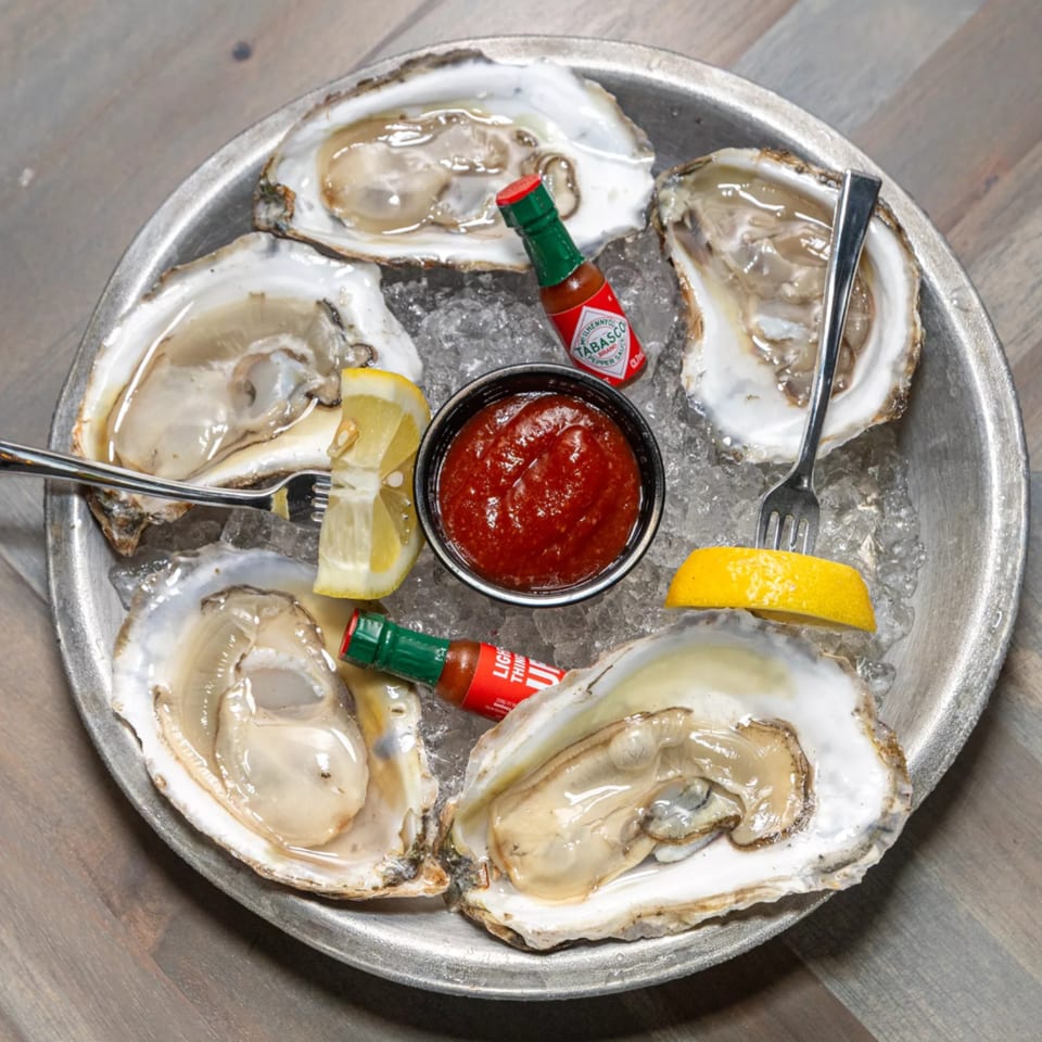 Island Beach Fish Company oysters on the half shell with lemon, cocktail sauce, and Tabasco.